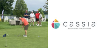 A golfer stands on the putting green